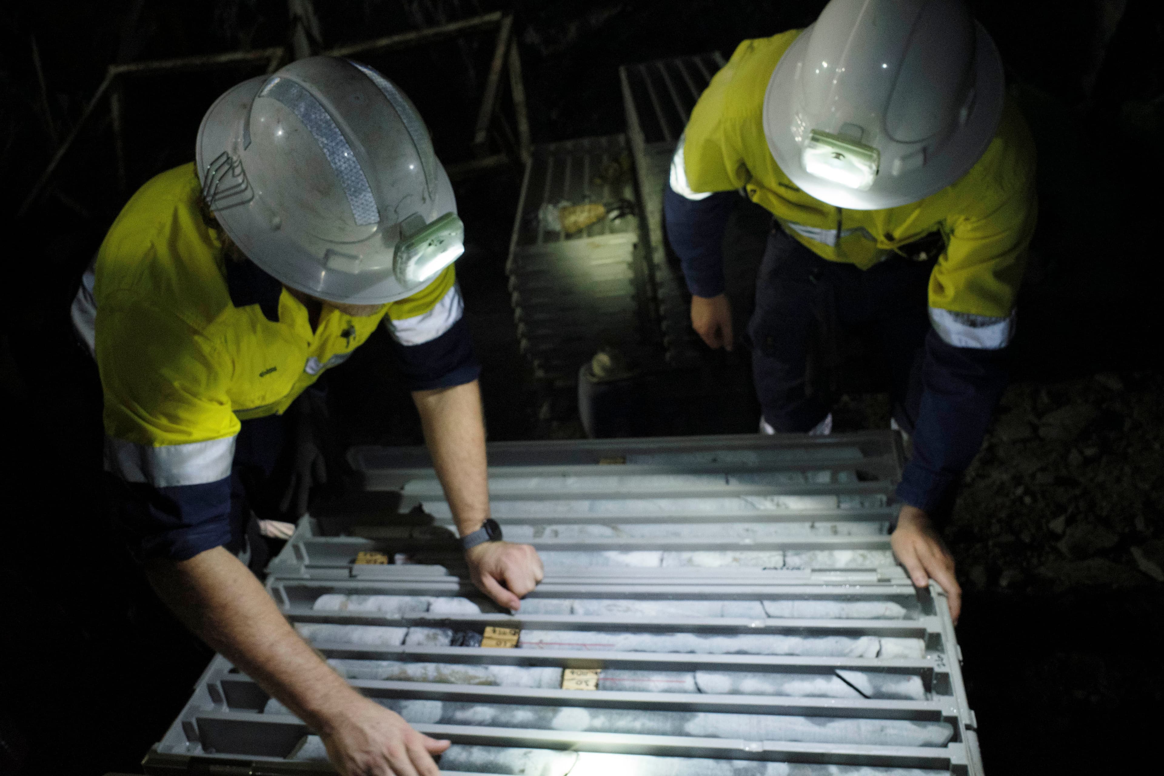geologists inspecting core samples underground